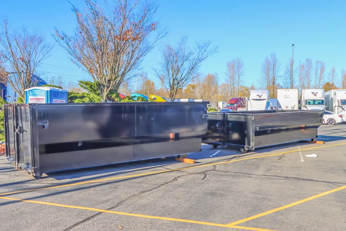 Professional dumpster rental service with roll-off container on residential driveway in Columbia Heights